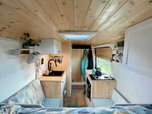 Camper Interior with wooden roof, white cabinets, and bamboo countertops