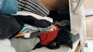 Colourful clothing folded in a cupboard